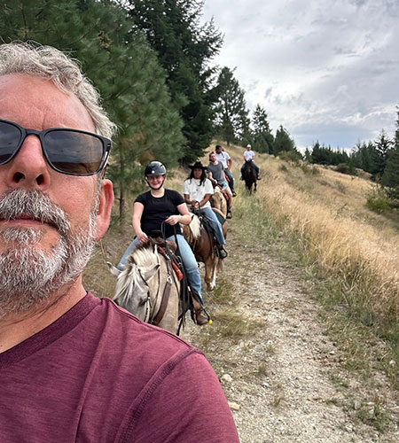 Okanagan Stables offers a classic horseback riding experience on guided trails..